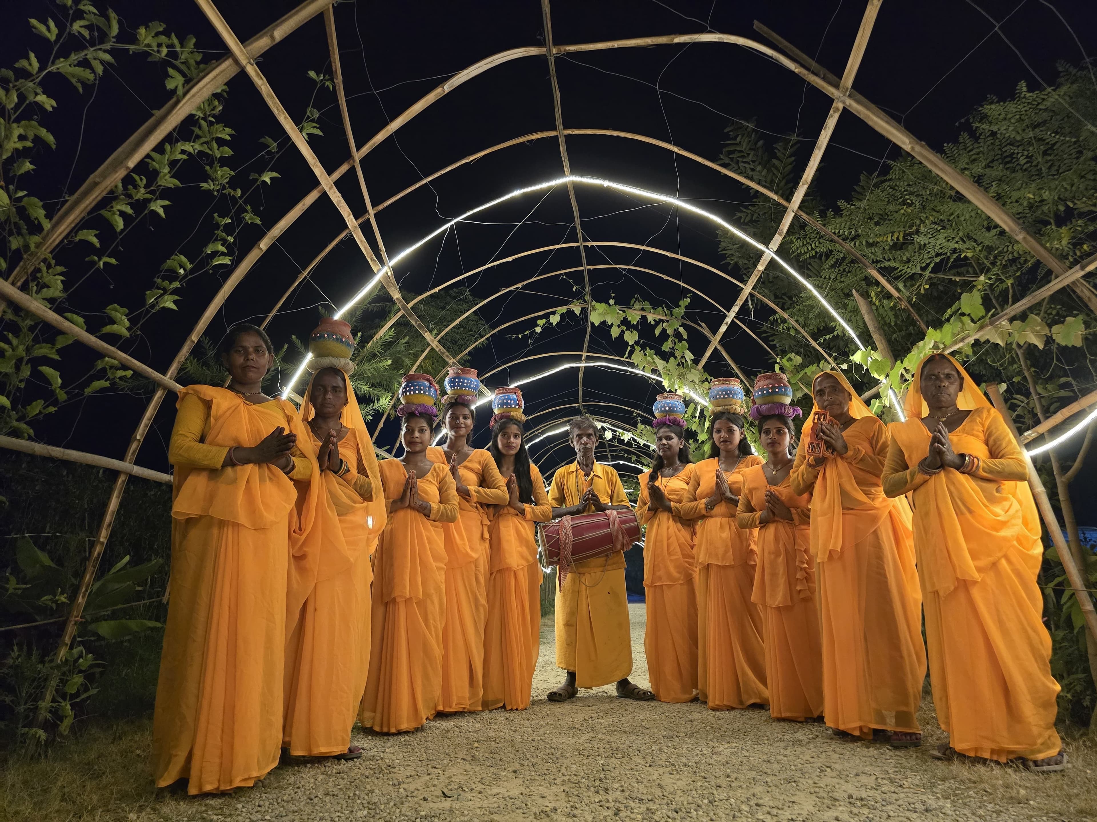 Traditional performers in illuminated bamboo tunnel
