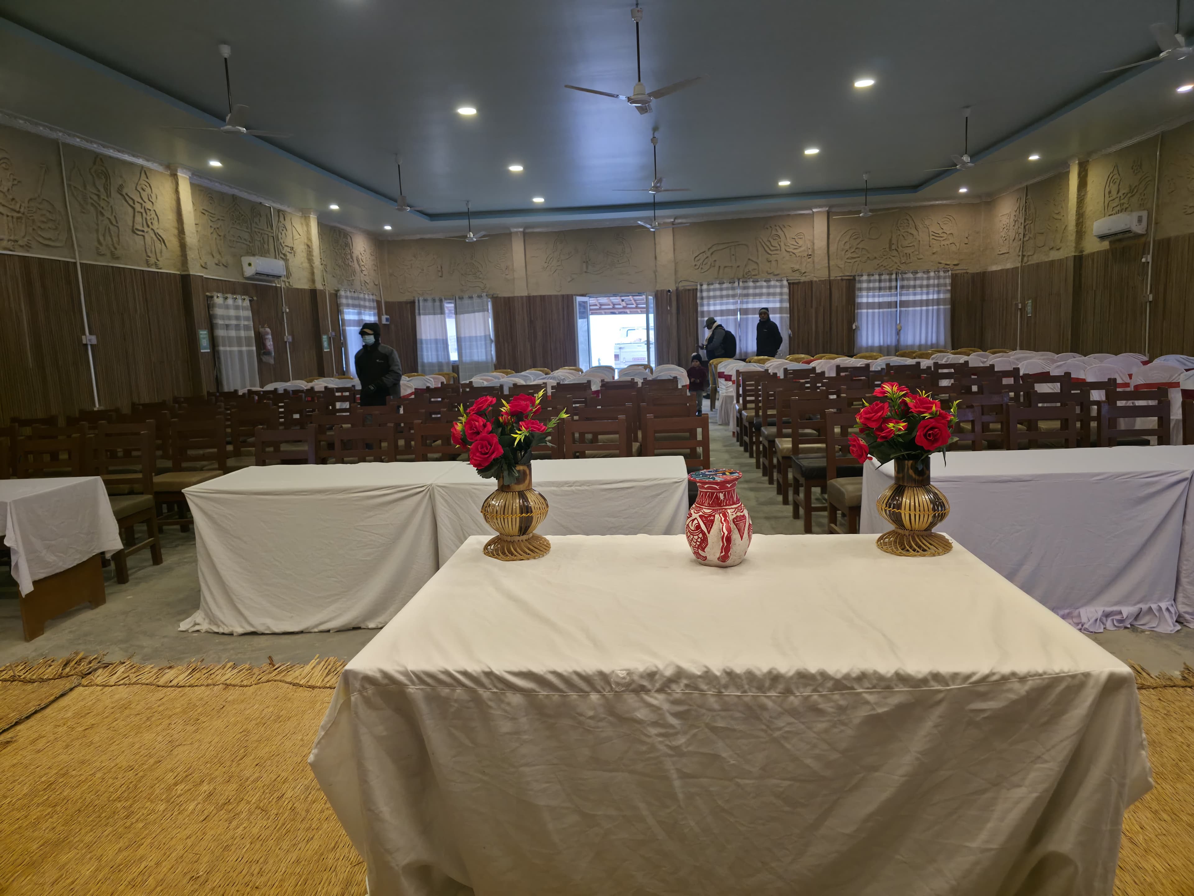 Banquet hall with Mithila relief art and flower arrangement